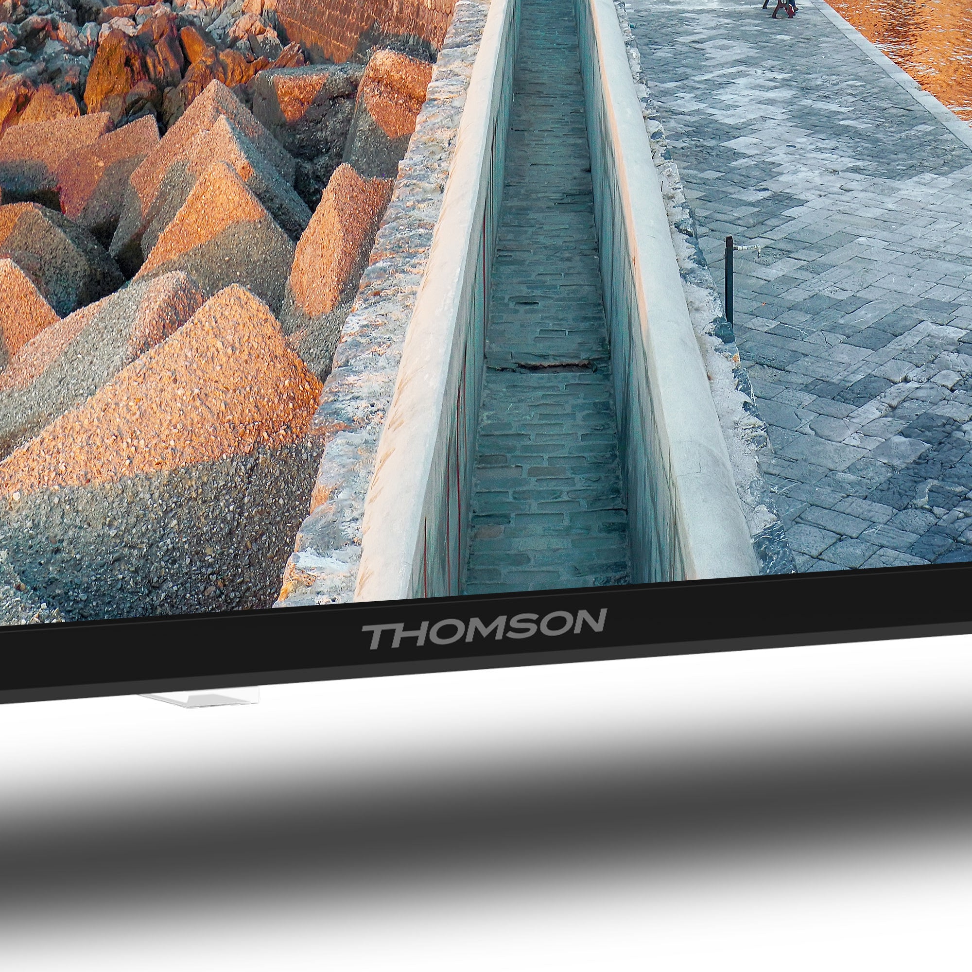 Close-up of a Thomson television screen with a scenic background