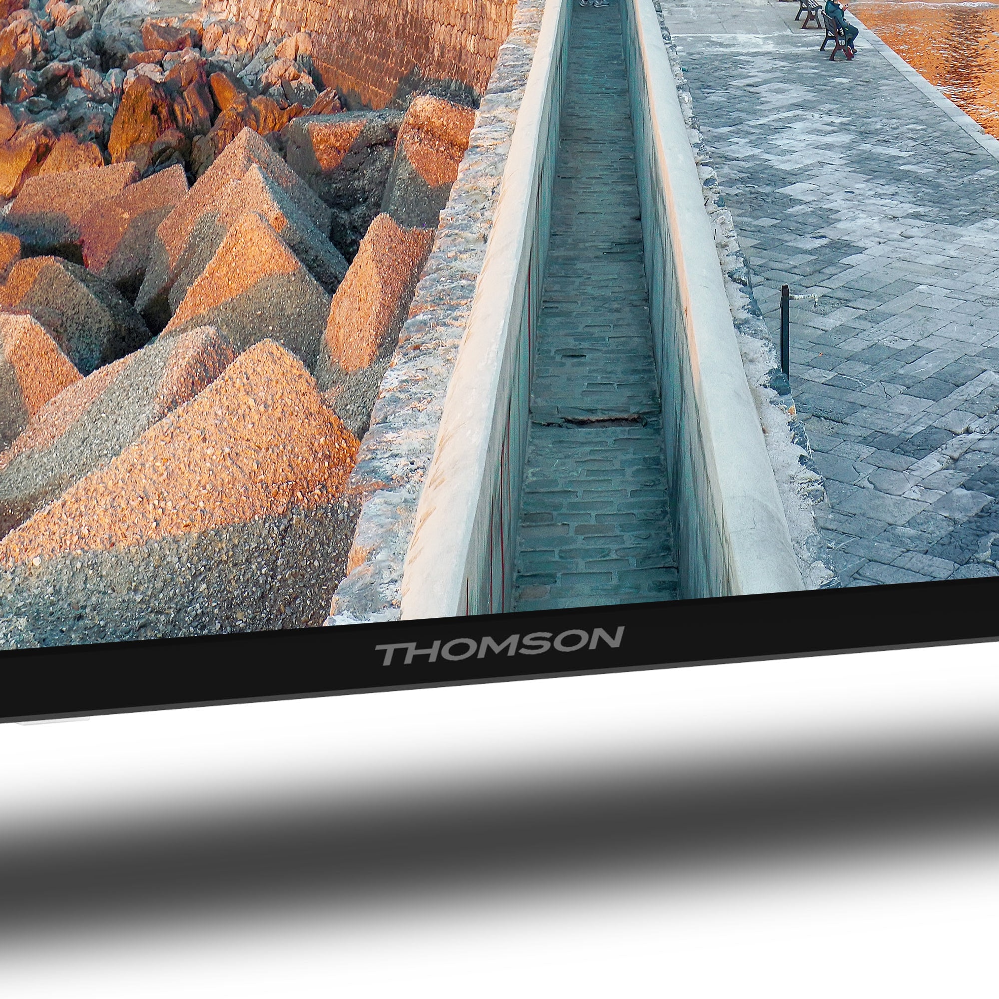 THOMSON TV screen displaying a scenic view of rocks and water.