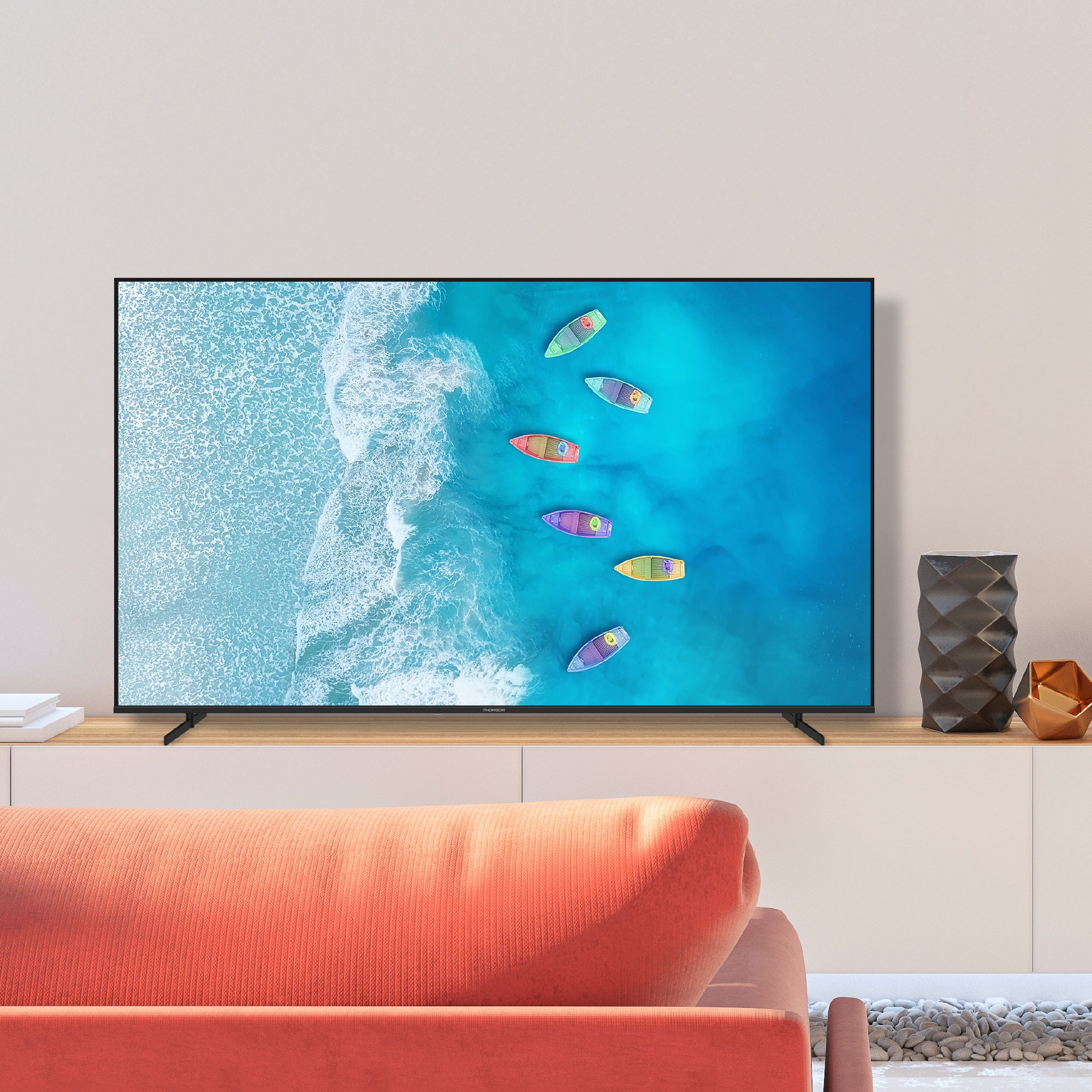 TV displaying an ocean scene with boats in a modern living room.