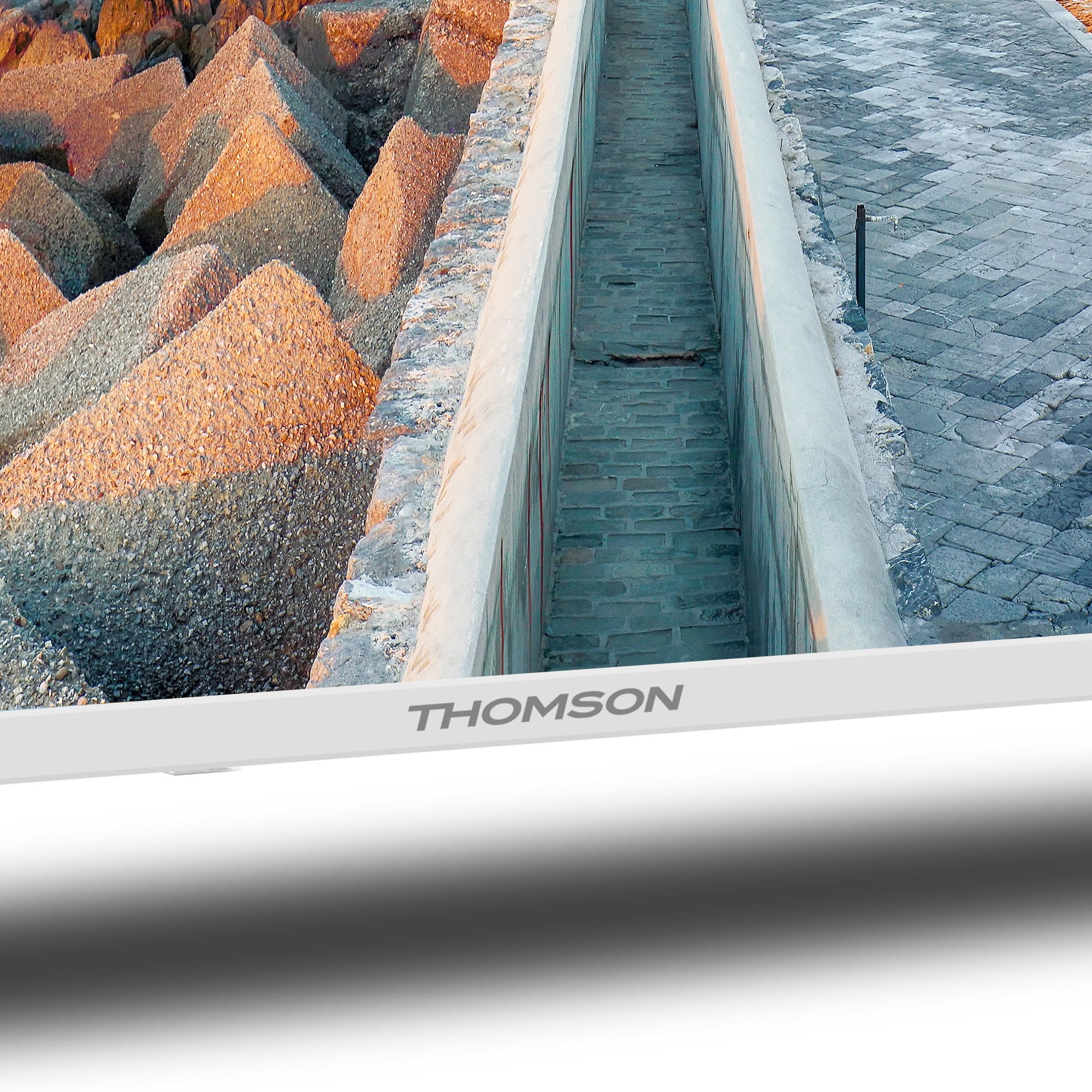Thomson TV screen displaying a scenic view with rocks and water.