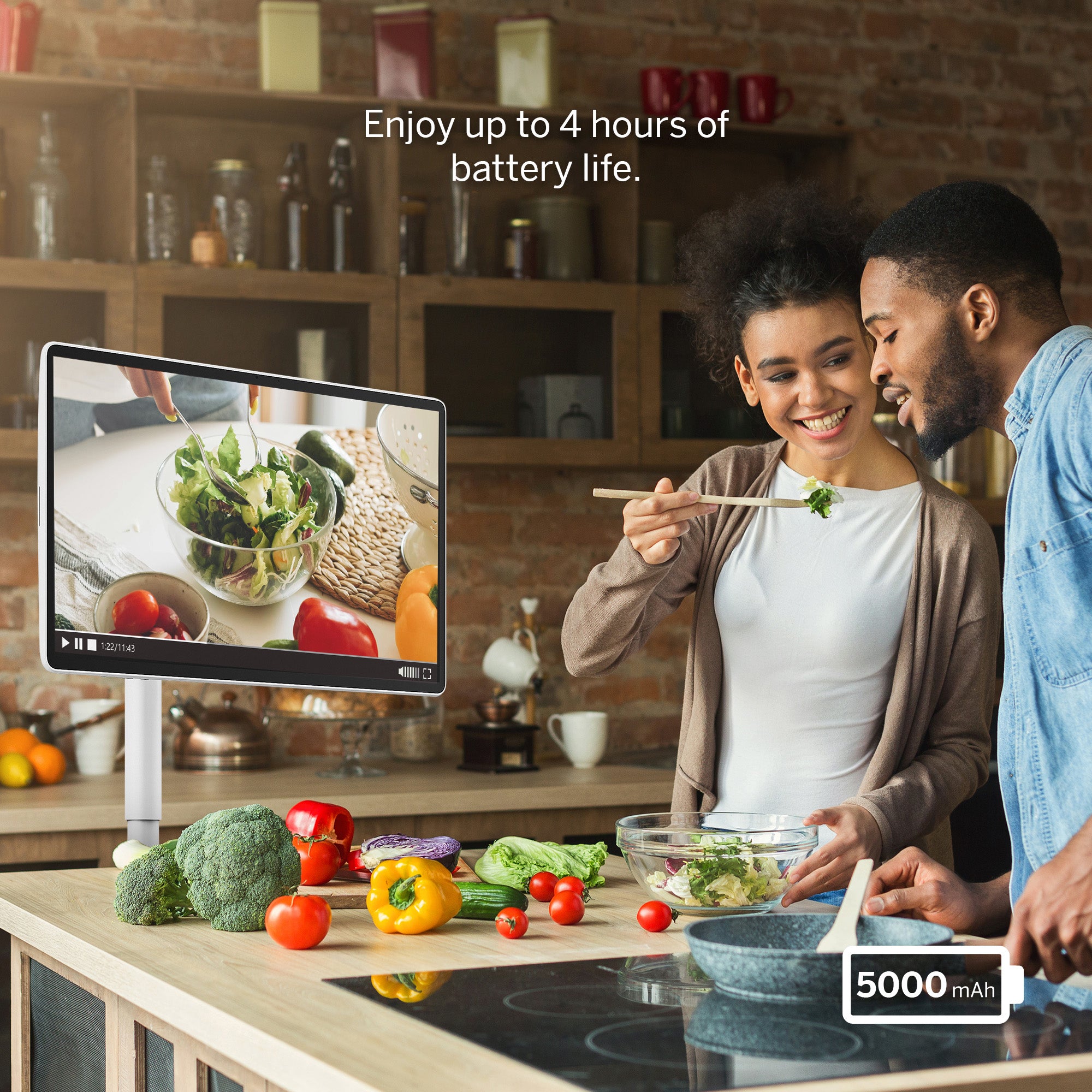 Couple in a kitchen with a tablet displaying a recipe, surrounded by vegetables.